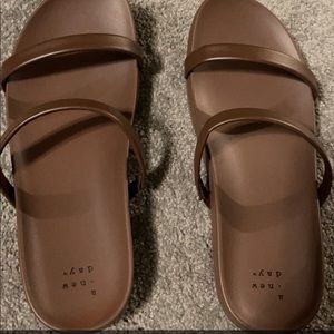 Brand new “A new day” brown slides, size 7.5